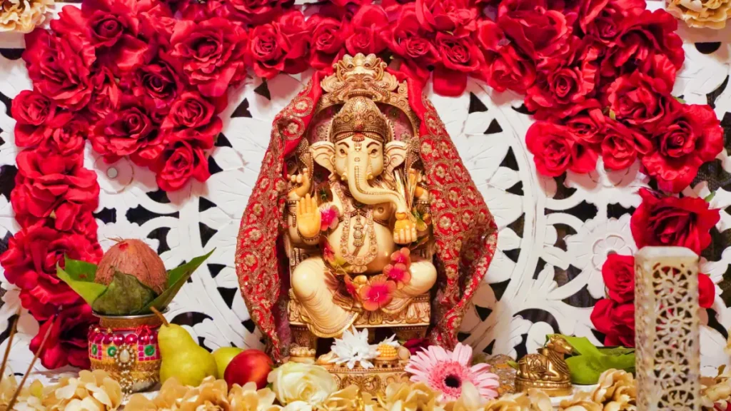 Lord Ganesh in traditional clay form with vibrant flower garlands, surrounded by colorful rangoli patterns and glowing diyas, celebrating Ganesh Chaturthi 2024. The festive background features hues of orange and gold, symbolizing joy and prosperity.